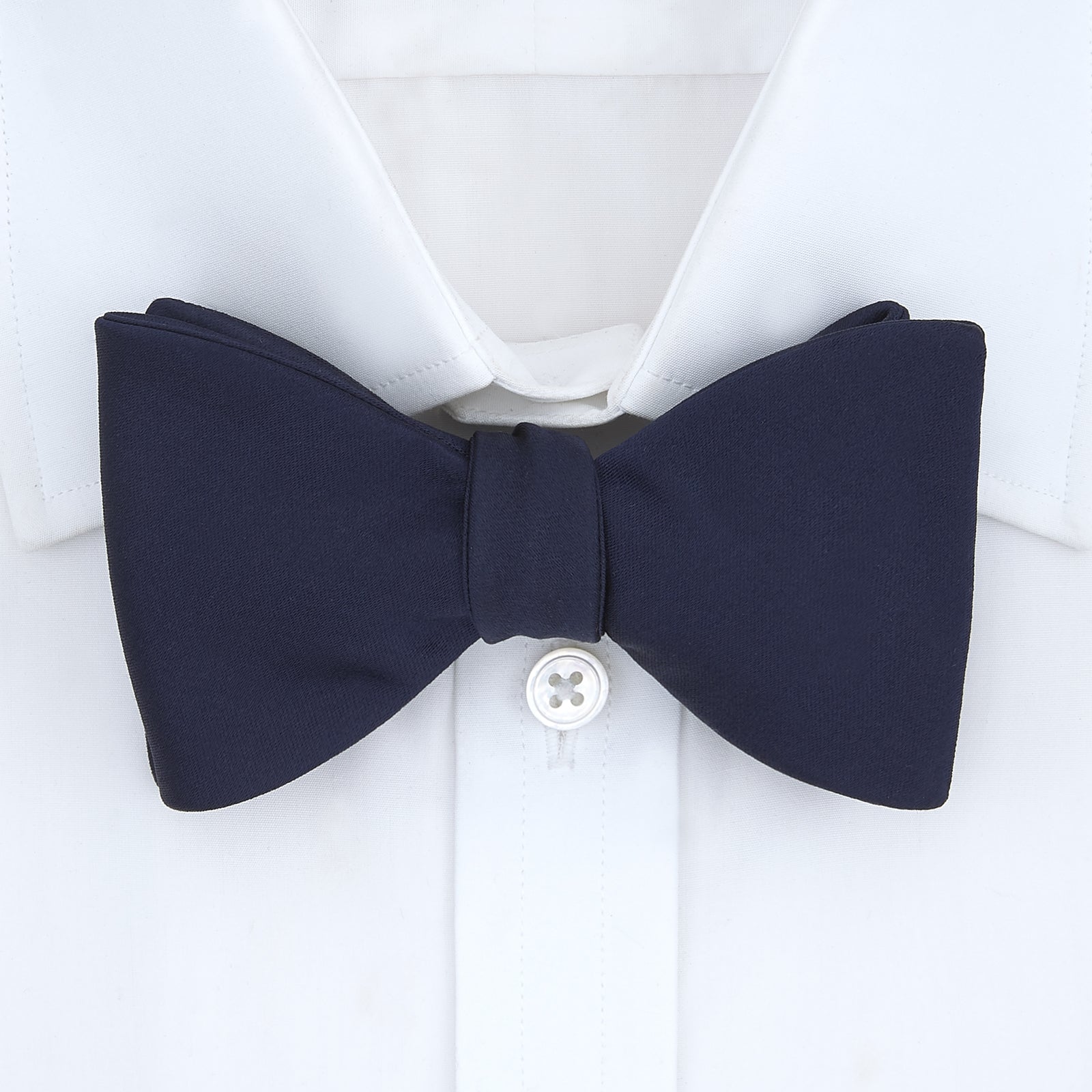 View 2 of product The Turnbull & Asser Navy Satin Silk Bow Tie is elegantly showcased against a plain white background.
