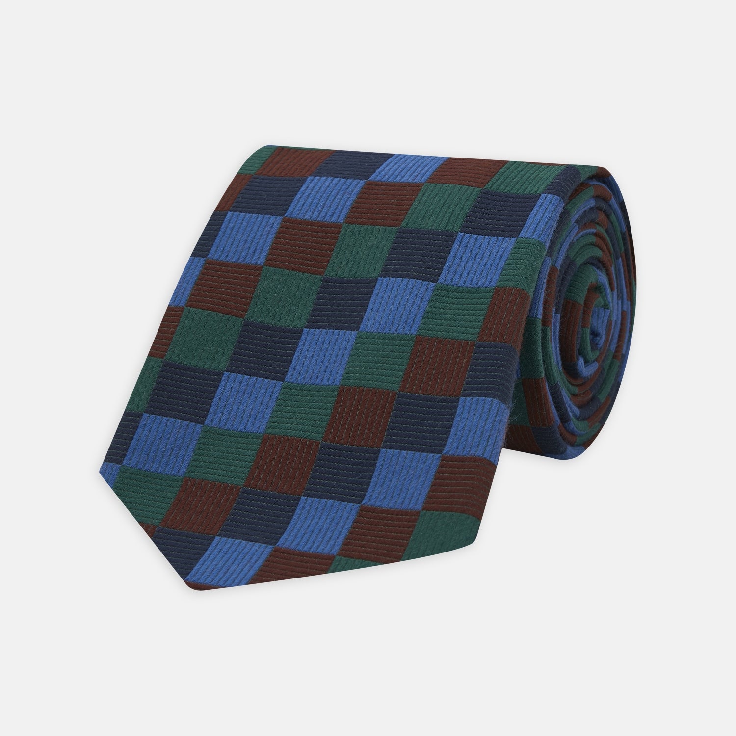View 1 of product The Turnbull & Asser Navy and Blue Checkerboard Jacquard Wool Tie showcases a stylish checkered pattern, ideal for adding refined autumn tones to your ensemble.