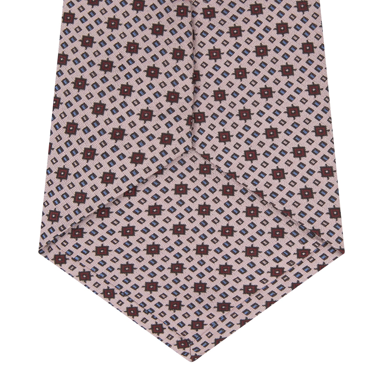 View 4 of product The Turnbull & Asser Pastel Pink Geometric Silk Tie features a small, repeating dark brown and white pattern for a mid-century look—ideal with tailored jackets. Shown rolled up on a white background.
