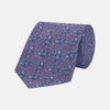 View 1 of product The Turnbull & Asser Purple Carp Silk Tie, woven in England, features blue koi fish and swirling patterns on purple silk and is shown against a plain white background.