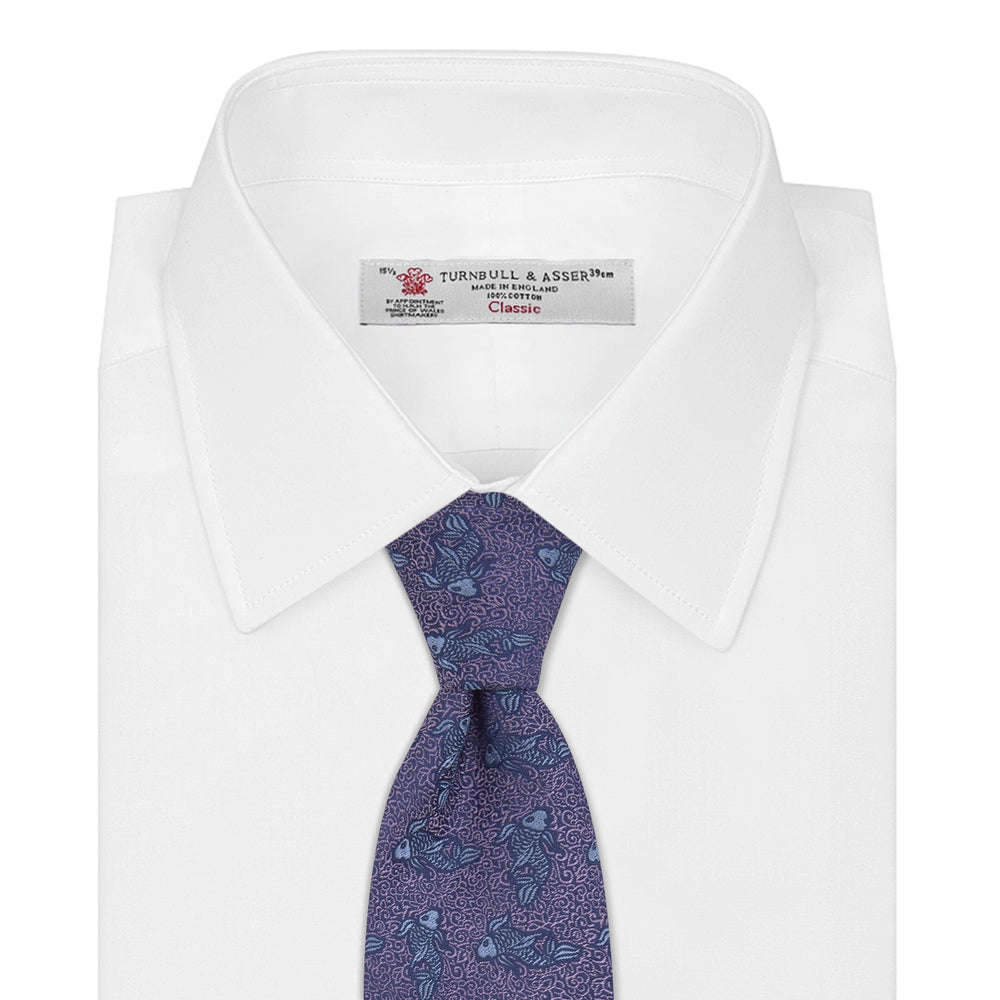 The Turnbull & Asser Purple Carp Silk Tie, woven in England, features blue koi fish and swirling patterns on purple silk and is shown against a plain white background.