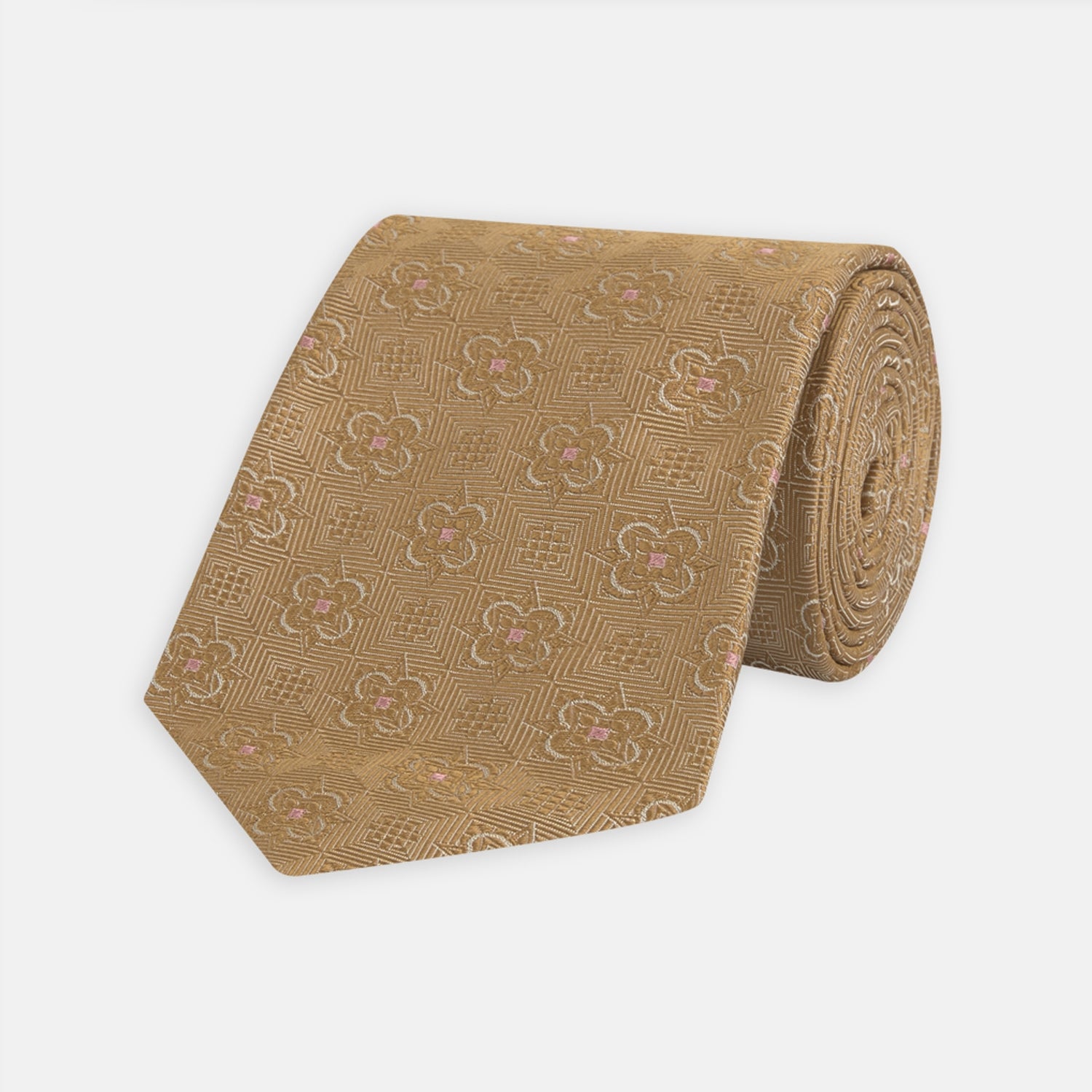 View 1 of product The Gold Flower Mosaic Silk Tie by Turnbull & Asser features an intricate gold jacquard pattern of geometric shapes and floral designs in pink and light brown hues.