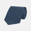 View 1 of product The Deep Turquoise Flower Mosaic Silk Tie by Turnbull & Asser features a jacquard design in blue with a subtle geometric pattern and small gold square accents evenly spaced across the fabric.