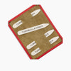 View 1 of product The Bone Collar Stays in Red Leather Lined Olive Suede Tray by Turnbull & Asser securely stores six metal stays, each branded, in a stylish red-edged leather case with organized compartments and an olive suede interior.