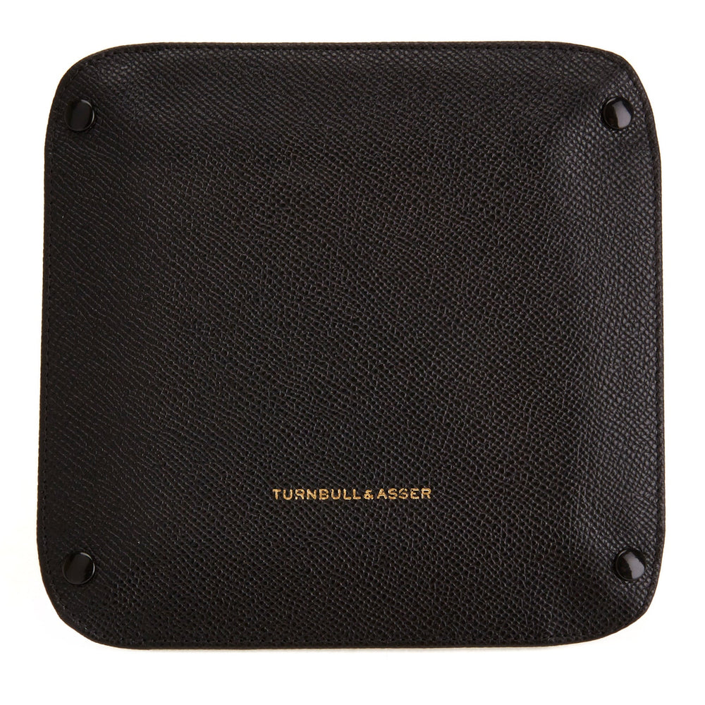The Turnbull & Asser Black and Red Square Leather Travel Tray features a black exterior, red suede interior, raised edges, and snapped corners—an essential for organizing small accessories. Shown on a white background.