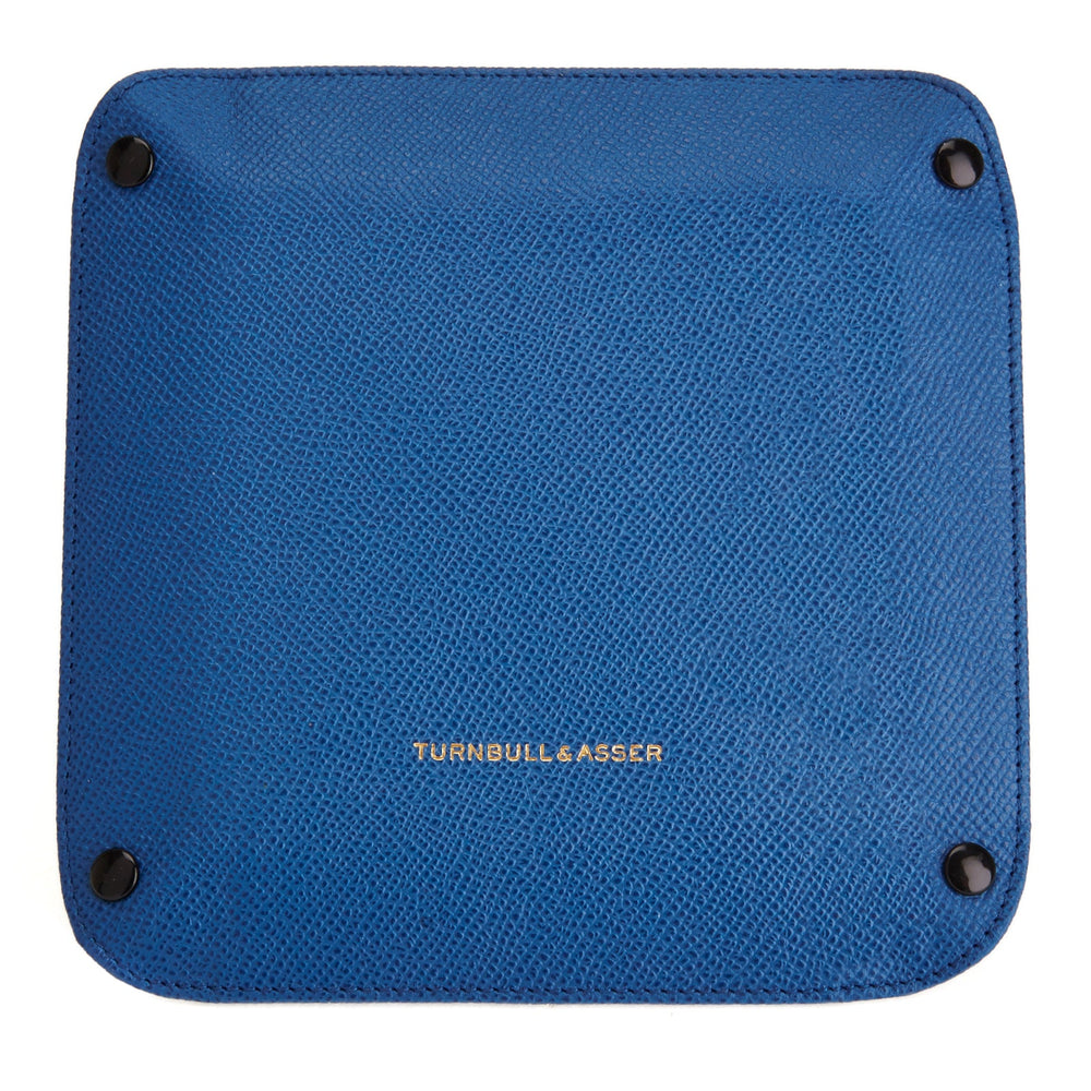 The Turnbull & Asser Royal Blue Square Leather Travel Tray, featuring raised edges and snap buttons at each corner, is ideal for organizing small accessories; shown against a plain white background.