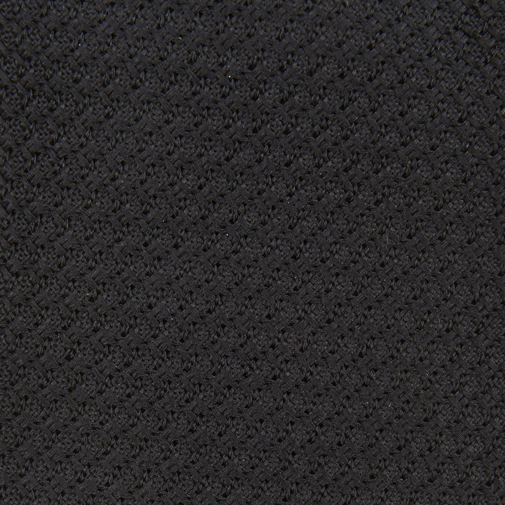 The Turnbull & Asser Long Black Grenadine Silk Tie features a subtle woven pattern and knitted appearance, shown rolled at one end against a plain white background.