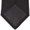 View 3 of product The Turnbull & Asser Long Black Grenadine Silk Tie features a subtle woven pattern and knitted appearance, shown rolled at one end against a plain white background.