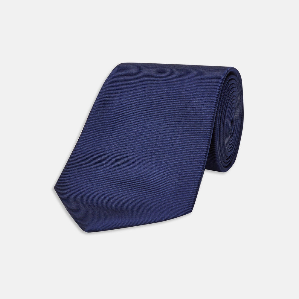 The Slim Navy Twill Silk Tie by Turnbull & Asser features a classic textured design—perfect with a cotton shirt—neatly displayed on a white background.