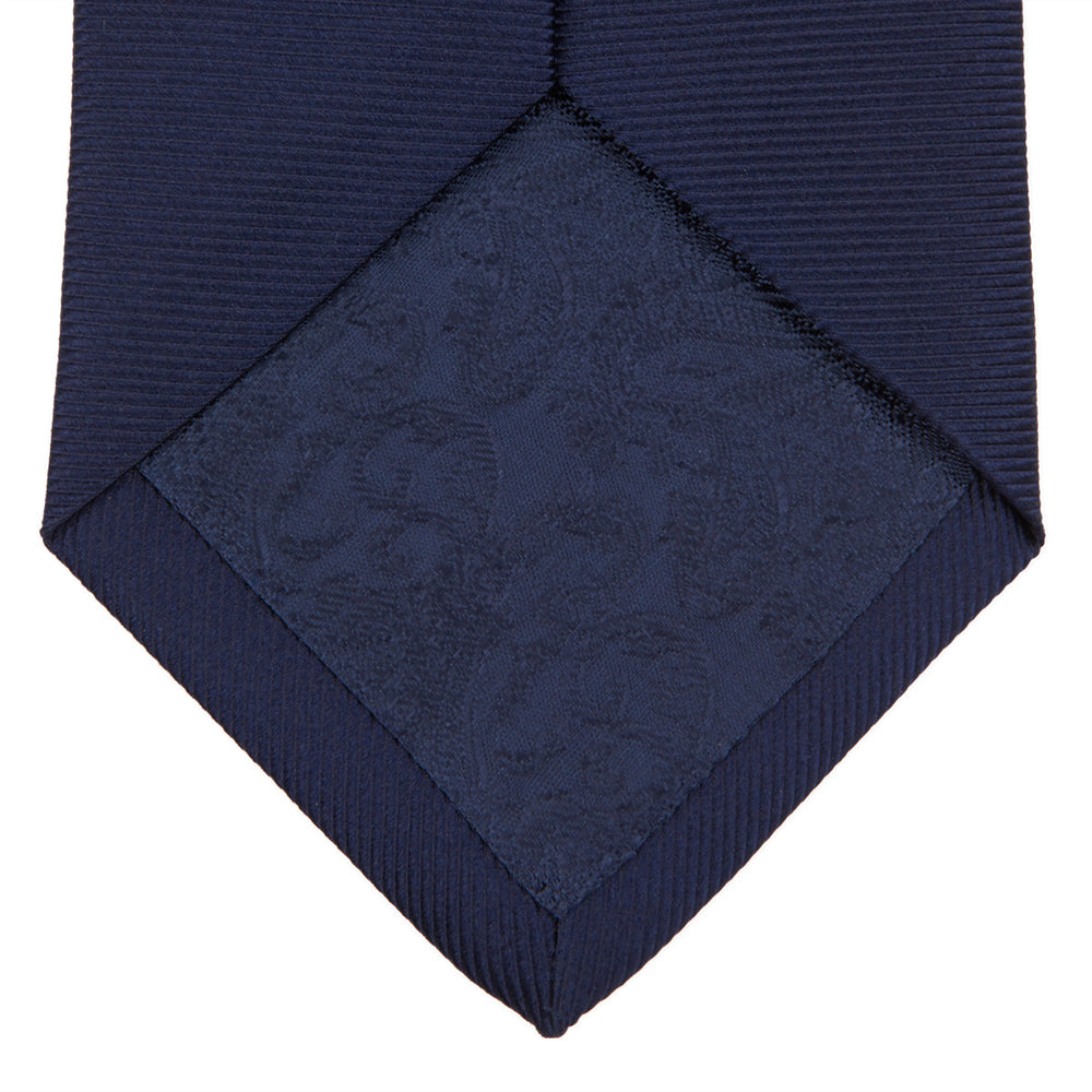 The Turnbull & Asser Navy Horizontal Twill Silk Tie features a subtle textured pattern and is elegantly displayed on a plain white background—ideal for pairing with cotton shirts for a smart, refined look.