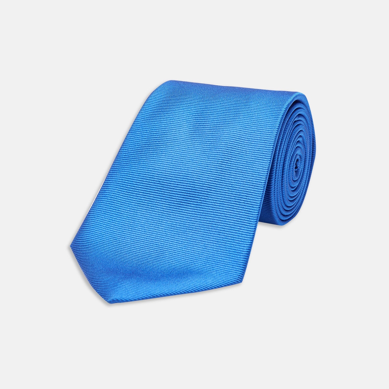 View 1 of product The Turnbull & Asser Slim Royal Blue Twill Silk Tie features a refined twill texture in bright blue, displayed on a white background—an ideal smart accent to pair with cotton shirts.
