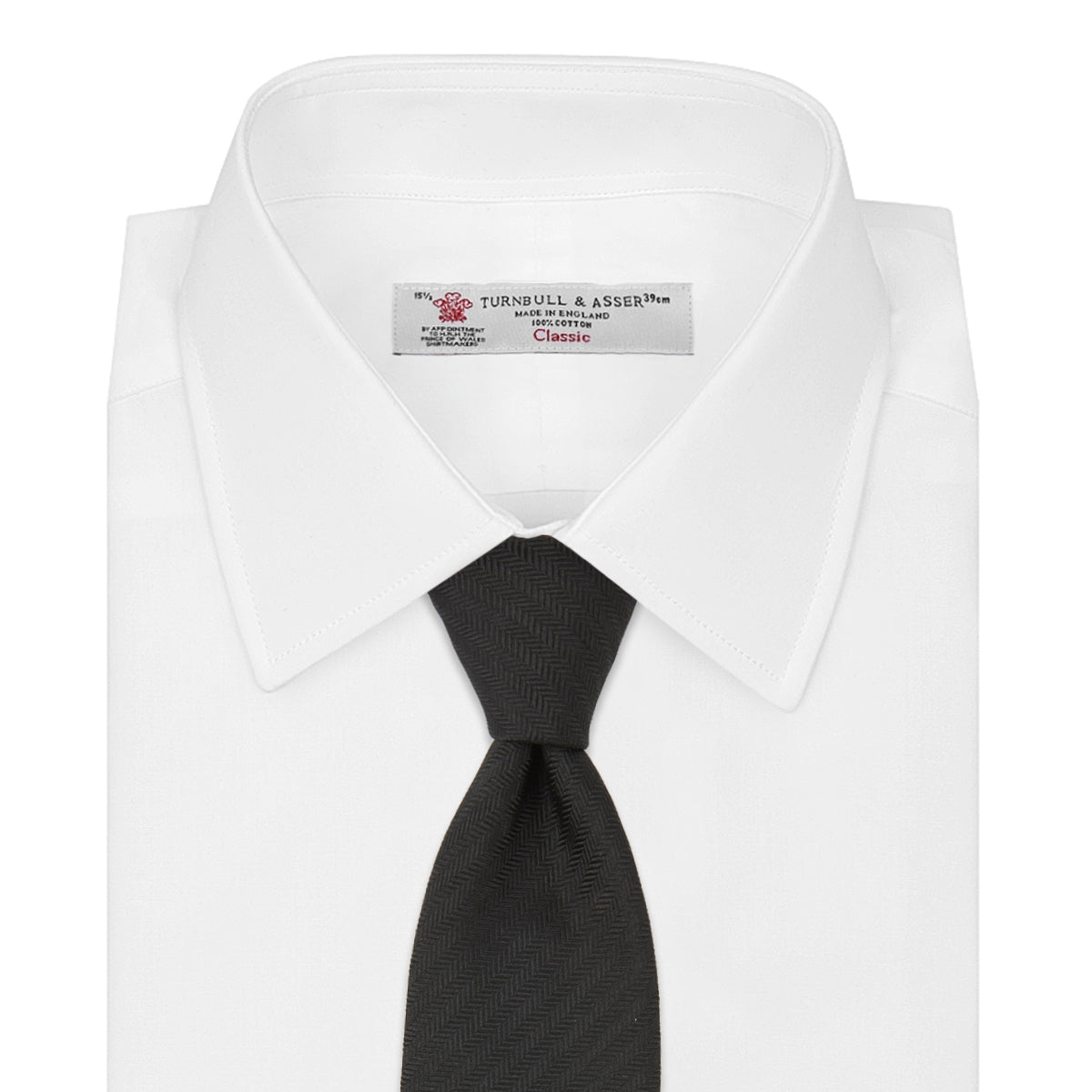 View 2 of product A Long Black Herringbone Silk Tie by Turnbull & Asser is shown rolled up on a plain white background.