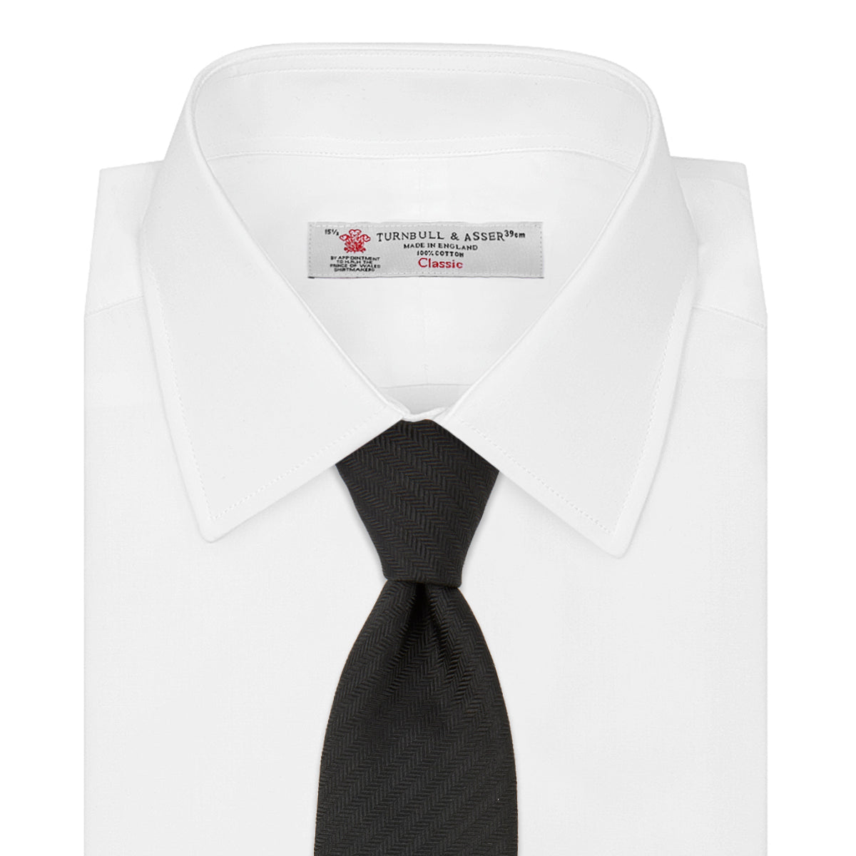 View 2 of product The Turnbull & Asser Black Herringbone Silk Tie is rolled up and displayed on a plain white background, showcasing its classic style and subtle chevron pattern.