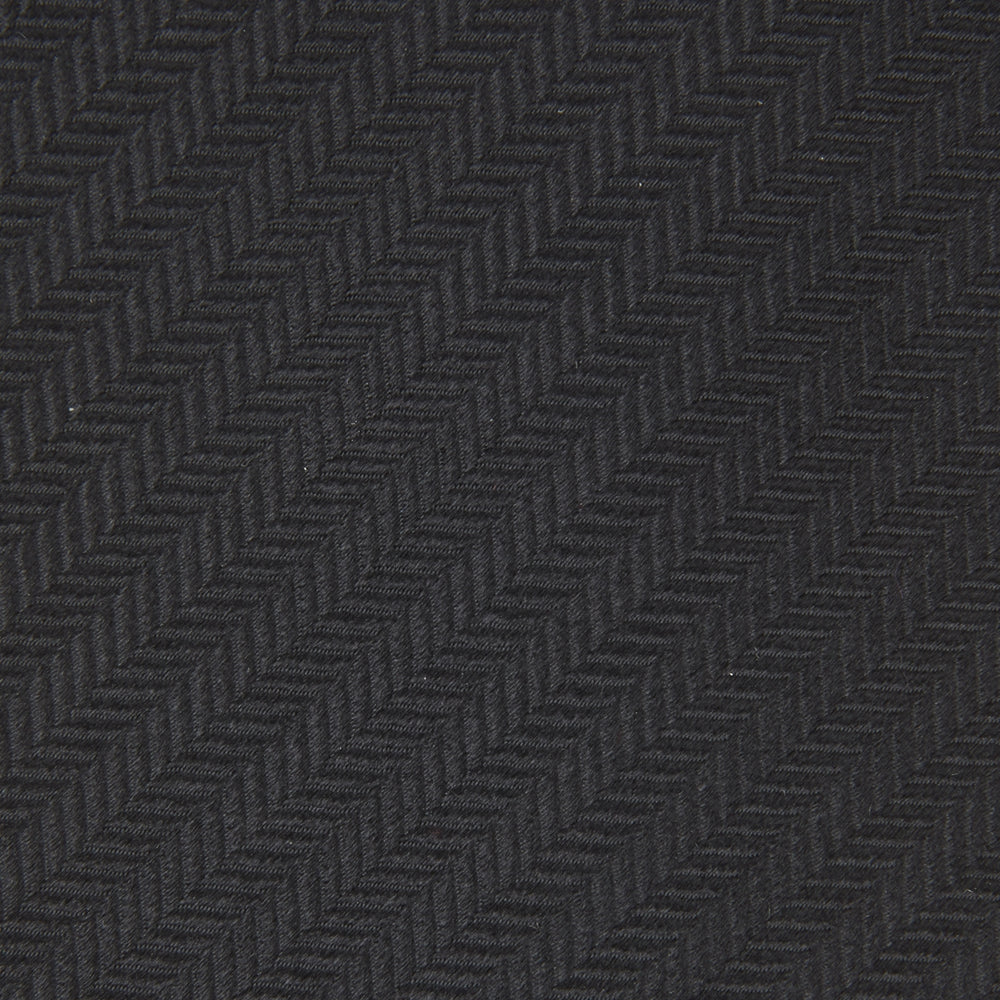 The Turnbull & Asser Slim Black Herringbone Silk Tie is neatly rolled, showcasing its subtle weave on a plain white background.