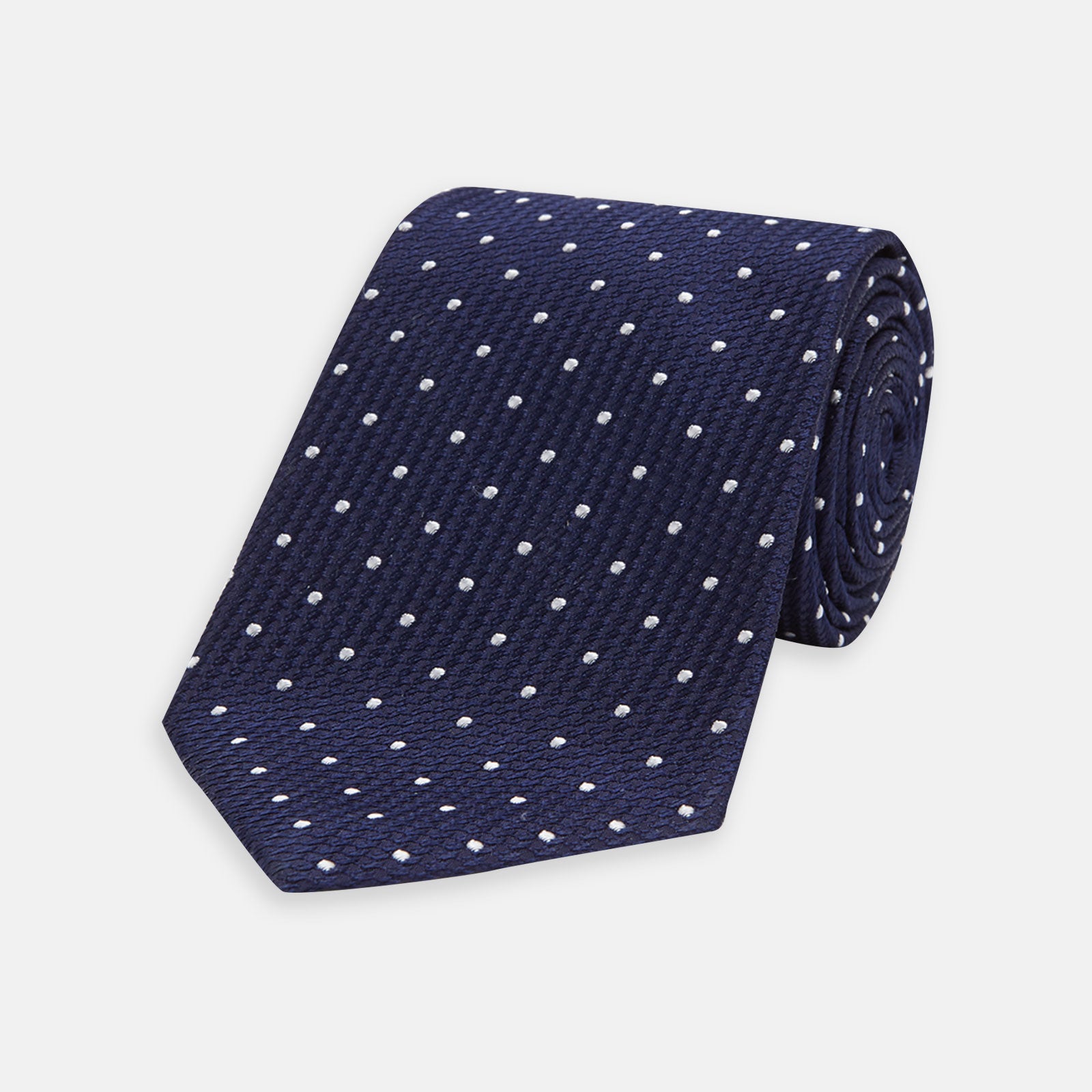 View 1 of product The Turnbull & Asser Navy and White Spot Lace Silk Tie features evenly spaced small white polka dots—perfect for adding a classic touch to any office shirt.
