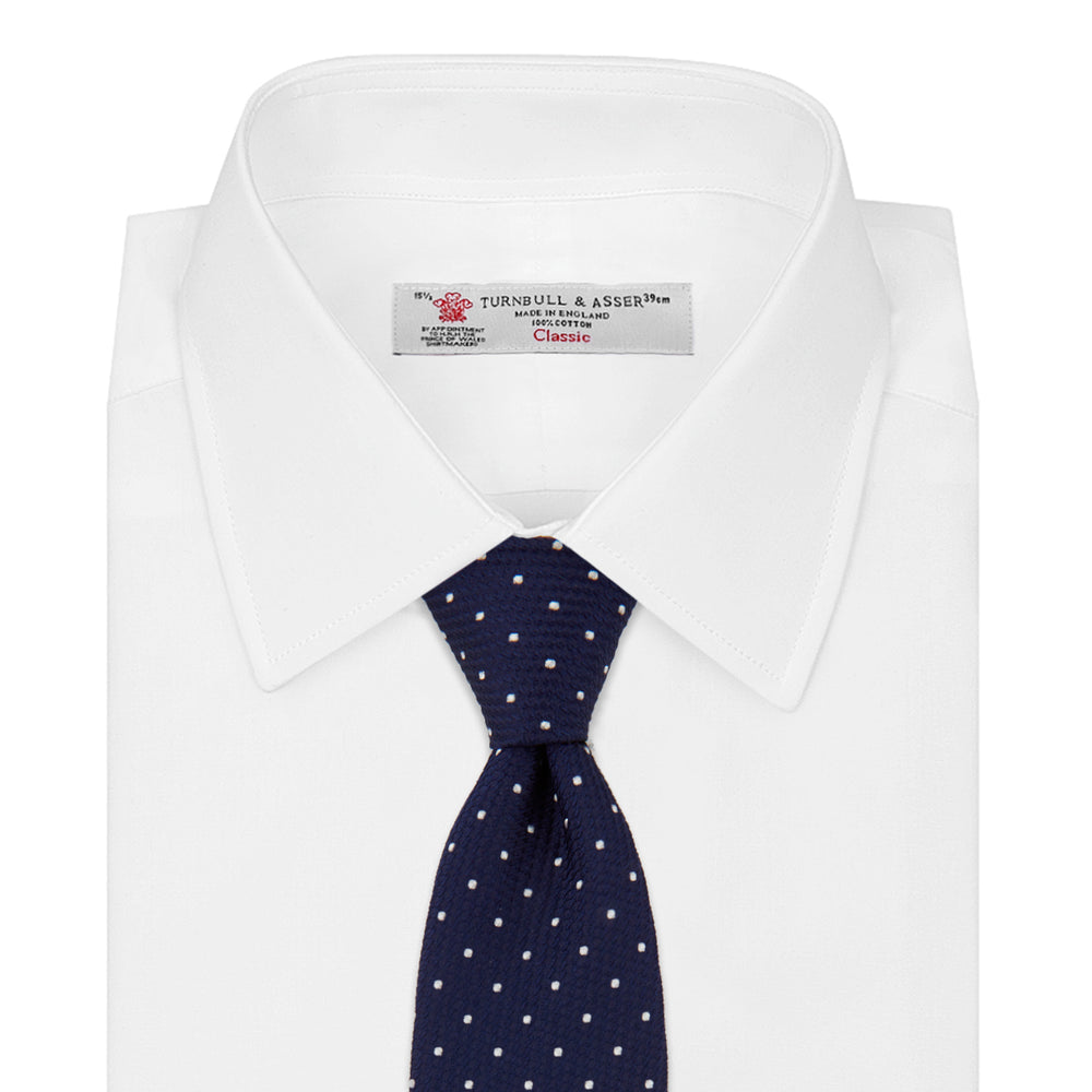 The Turnbull & Asser Navy and White Spot Lace Silk Tie features evenly spaced small white polka dots—perfect for adding a classic touch to any office shirt.
