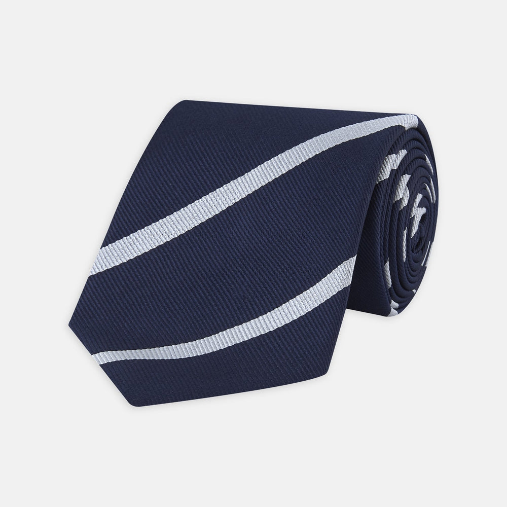 Turnbull & Asser’s Slim Navy and White Blazer Stripe Repp Silk Tie features two white diagonal stripes, rolled neatly on a white background—an ideal accessory to complement any office shirt.