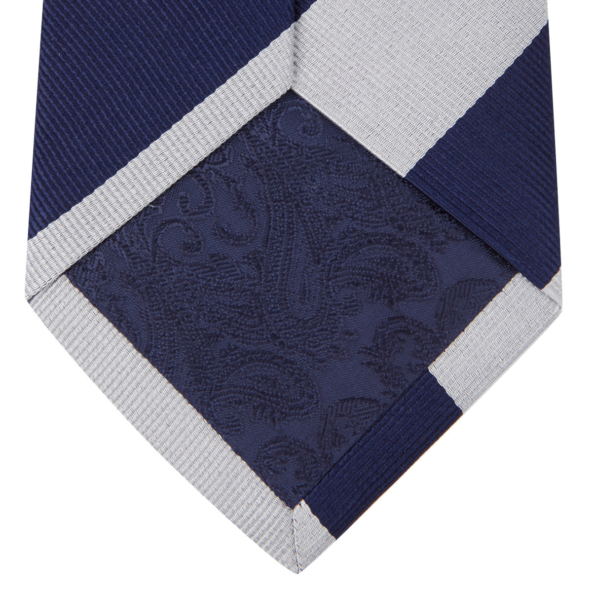 View 4 of product The Turnbull & Asser Navy and Off-White Block Stripe Repp Silk Tie features wide diagonal stripes, ideal for pairing with an office shirt against a plain light background.