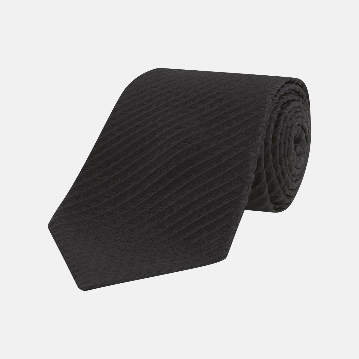 View 1 of product The Black Ottoman Silk Tie by Turnbull & Asser features a subtle wavy textured pattern and is crafted from heavyweight ribbed silk, shown rolled up against a plain white background.
