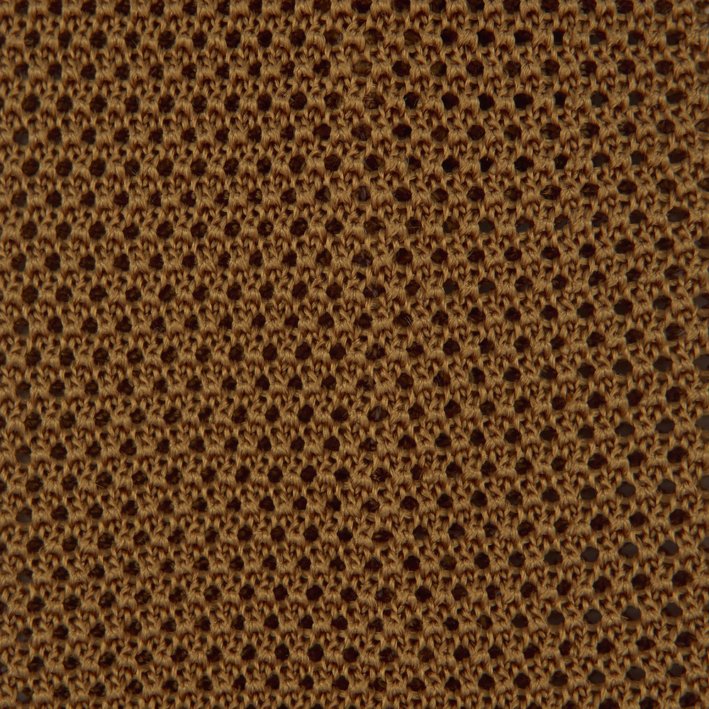 The Gold Knitted Silk Tie by Turnbull & Asser, featuring a textured pattern, is elegantly displayed on a plain white background.