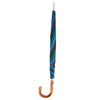 View 2 of product The Turnbull & Asser Blue and Green Umbrella with Chestnut Crook features three colored panels—navy, green, bright blue—and a sturdy chestnut handle with a silver shaft, ideal for English weather. Shown on a plain white background.