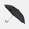 View 1 of product A brown Turnbull & Asser telescopic umbrella with a black maple crook handle, opened and displayed against a plain white background.