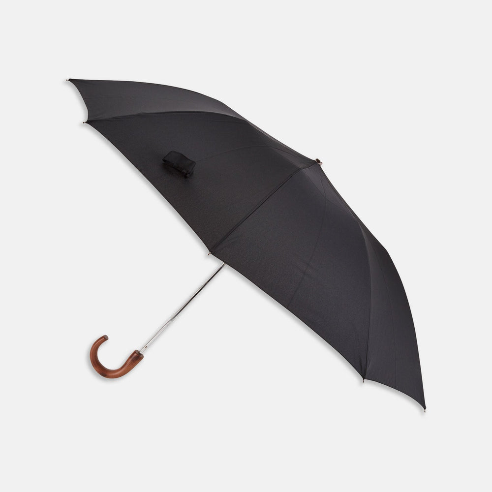 A brown Turnbull & Asser telescopic umbrella with a black maple crook handle, opened and displayed against a plain white background.