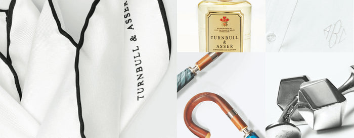 A collage featuring a monogrammed white shirt, Turnbull & Asser cologne, a white handkerchief with black trim, an umbrella with a wooden handle, and metal cufflinks.