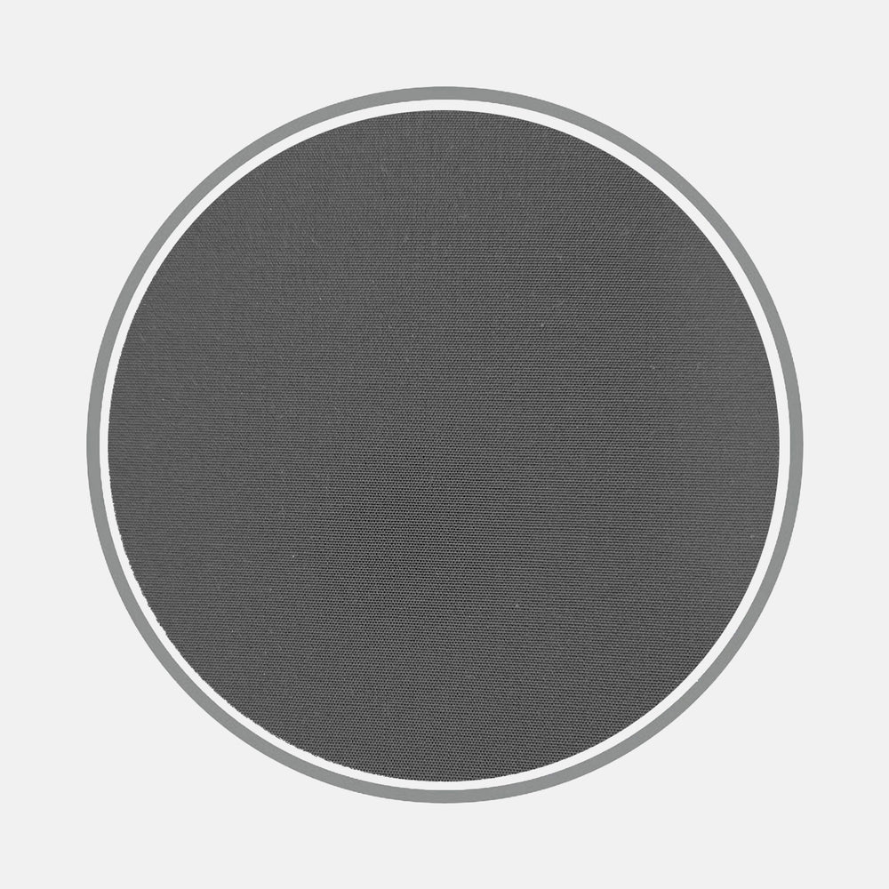 A plain black cotton circle, representing Turnbull & Asser's fabric, is centered on a light gray background with a thin white border and a textured surface outlined by a thicker gray ring.
