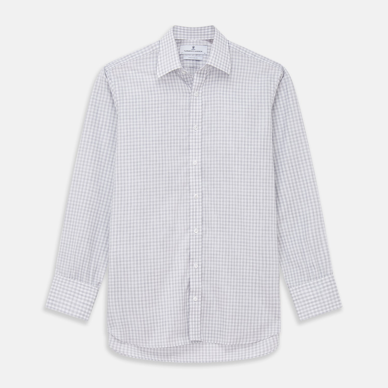 View 2 of product Close-up of Turnbull & Asser’s Grey Check Cotton Fabric, featuring a light gray and white plaid pattern in a circular frame that highlights the smooth texture and crisp intersecting lines.