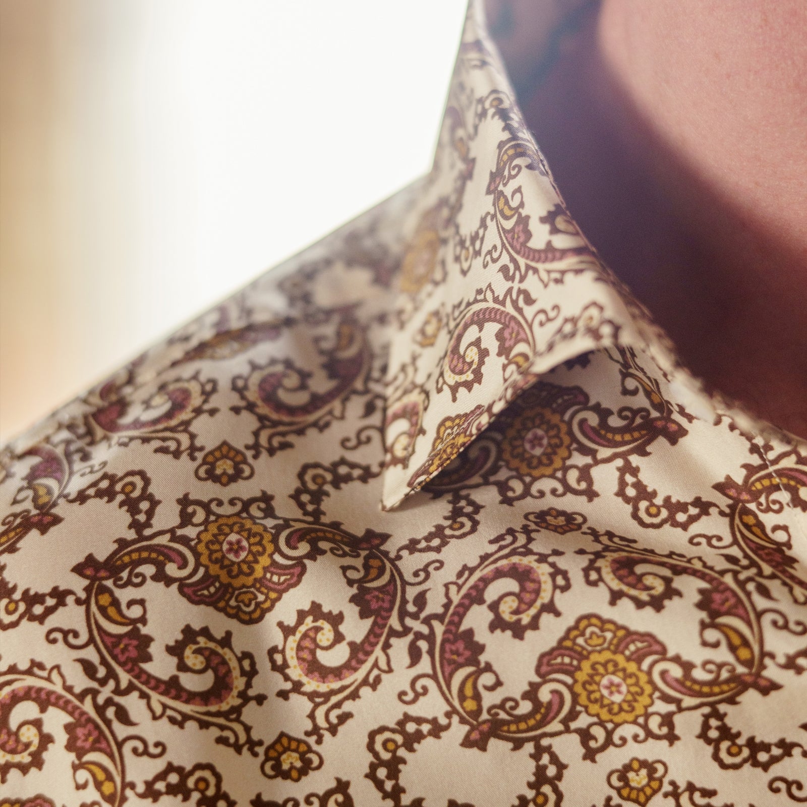 View 4 of product The Turnbull & Asser Tailored Fit Cream Jagger Print Silk Shirt features a Kent collar, 2-button cuffs, and an intricate brown and gold print on cream silk for timeless elegance.