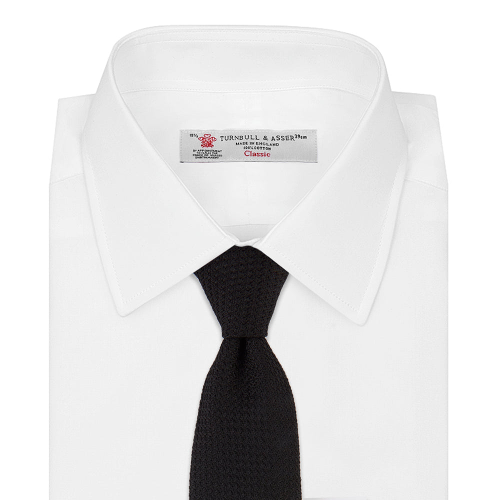The Turnbull & Asser Seven-Fold Black Grenadine Silk Tie, displayed on a white background, adds a refined touch of luxury neckwear.