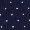 View 3 of product The Seven-Fold Navy and White Spot Lace Silk Tie by Turnbull & Asser showcases a luxurious navy silk with white spots, elegantly rolled and presented on a white background.