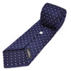 View 4 of product The Seven-Fold Navy and White Spot Lace Silk Tie by Turnbull & Asser showcases a luxurious navy silk with white spots, elegantly rolled and presented on a white background.