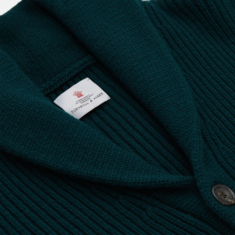 The Turnbull & Asser Ainsley Ribbed Shawl Neck Cardigan in holly green features a button-down front and two patch pockets, shown laid flat on a white background.
