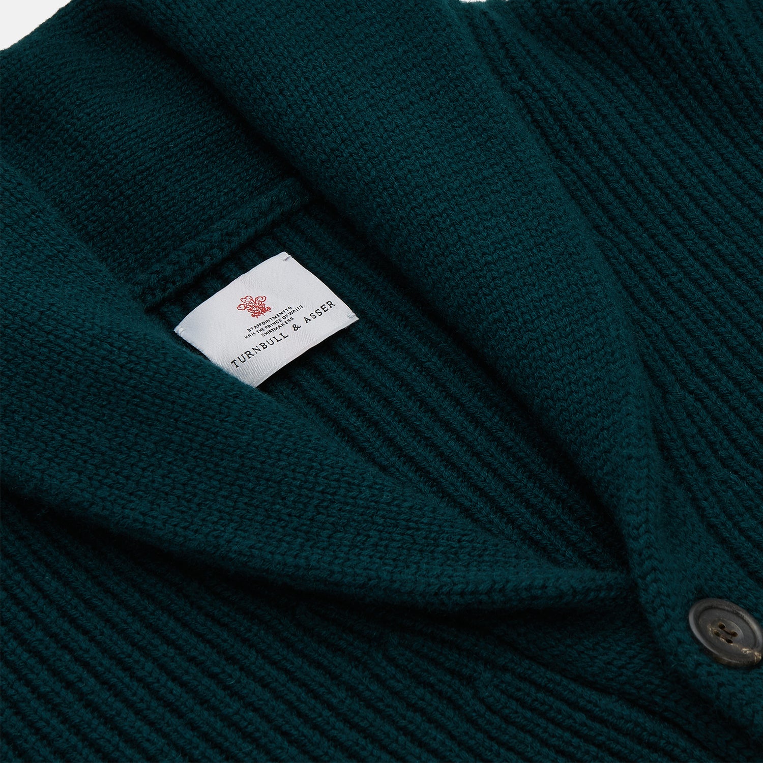 View 2 of product The Turnbull & Asser Ainsley Ribbed Shawl Neck Cardigan in holly green features a button-down front and two patch pockets, shown laid flat on a white background.
