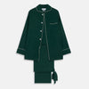 View 1 of product The Turnbull & Asser Dark Green Silk Pyjama Set features a long-sleeve button-up top with white piping, chest pocket, and matching pants, all neatly folded on a plain white background.