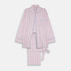 View 1 of product The Turnbull & Asser Pink And White Stripe Twill Cotton Pyjama Set features long sleeves and pants with a curved collar and blue trim on the cuffs, pocket, and hem—a classic gent’s style shown on a plain white background.