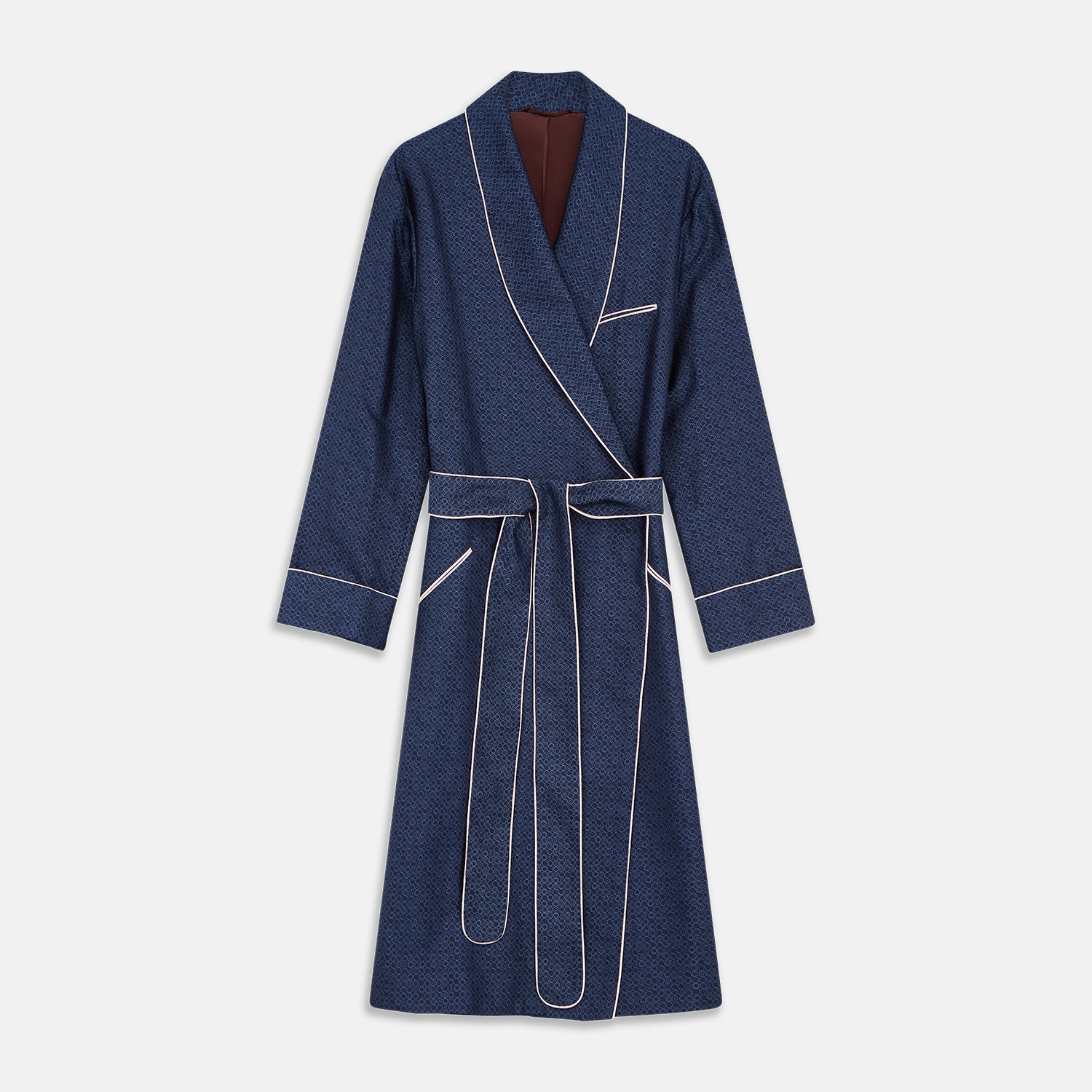 View 1 of product The Turnbull & Asser Blue Multi Circle Silk Jacquard Gown features a subtle geometric pattern, white piping, a chest pocket, and a matching waist belt, all showcased against a white background.