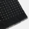 View 2 of product The Turnbull & Asser Black & White Spot Superfine Cashmere Scarf features evenly spaced white dots, lightly frayed edges, and a lightweight design for subtle elegance in any outfit. Shown laid flat with a loose knot at the top.