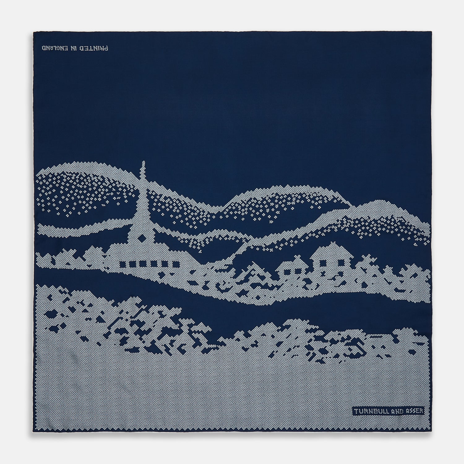 View 1 of product The Blue Snowscape Motif Silk Extra Large Scarf by Turnbull & Asser features a light blue village scene and hand-rolled edges, with TURNBULL AND ASSER at the bottom right and PRINTED IN ENGLAND at the top left.