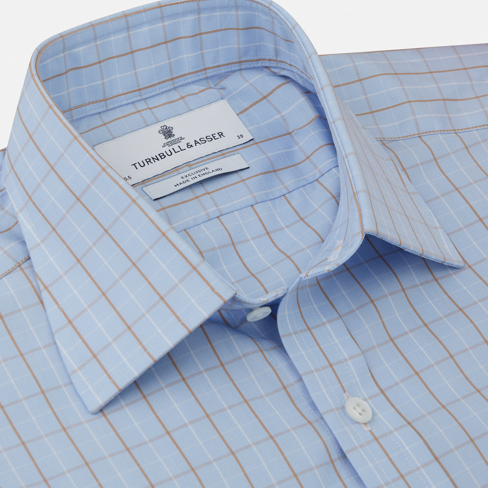 A beige graph check regular fit shirt by Turnbull & Asser, featuring a T&A collar and 3-button cuffs, is neatly laid flat on a white background.