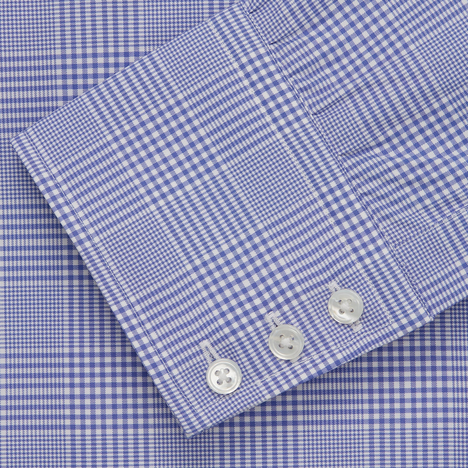 View 5 of product The Turnbull & Asser Blue Check Shirt features a T&A collar, 3-button cuffs, and a tonal blue check pattern in royal cotton twill. This long-sleeved, regular fit shirt is displayed on a white background.