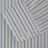 View 5 of product The Turnbull & Asser Blue and Brown Stripe Poplin Shirt features a T&A collar, three-button cuffs, and vertical blue, white, and tan stripes. This smart-casual shirt is displayed on a plain light background.