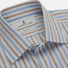 View 4 of product The Turnbull & Asser Blue and Brown Stripe Poplin Shirt features a T&A collar, three-button cuffs, and vertical blue, white, and tan stripes. This smart-casual shirt is displayed on a plain light background.