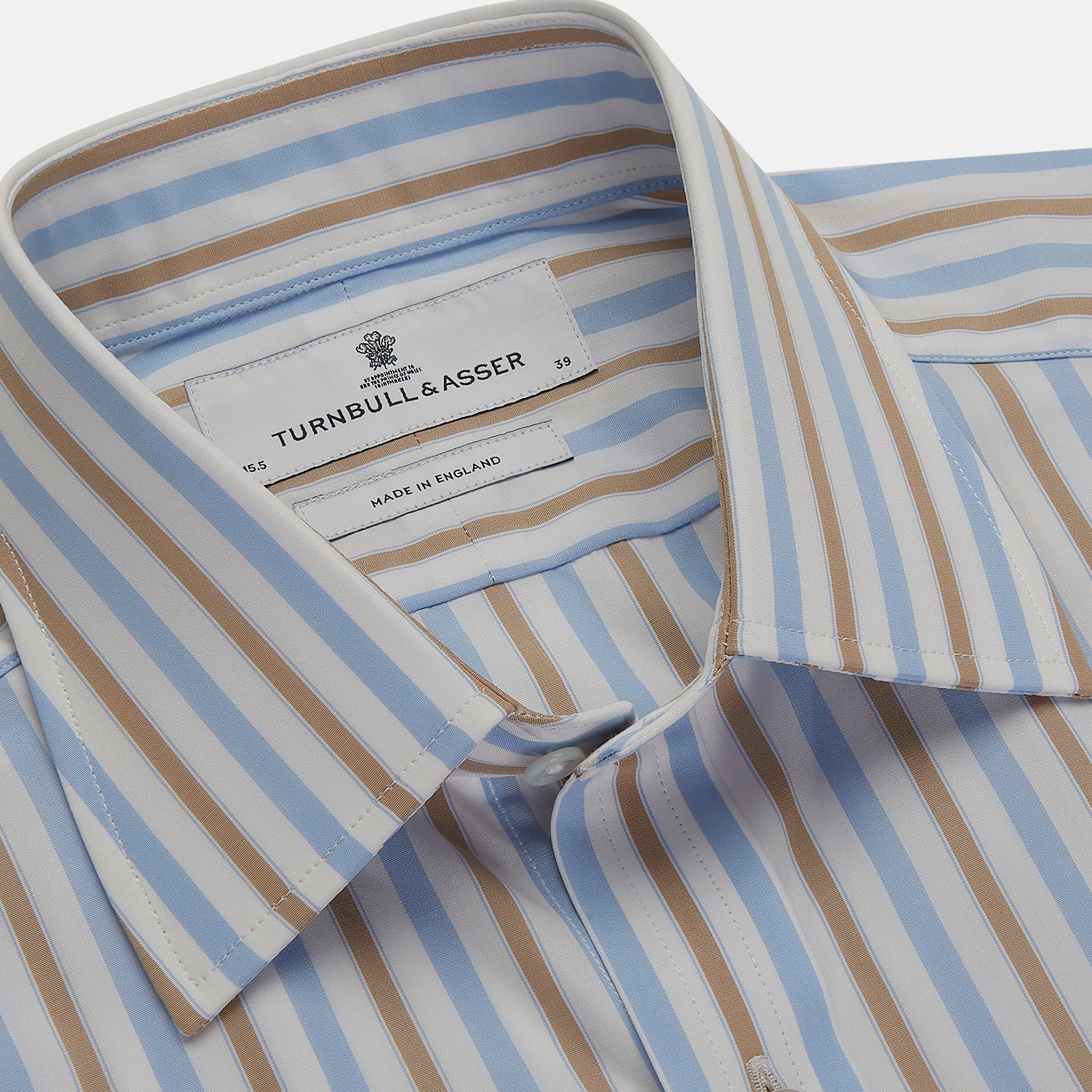 View 4 of product The Turnbull & Asser Blue and Brown Stripe Poplin Shirt features a T&A collar, three-button cuffs, and vertical blue, white, and tan stripes. This smart-casual shirt is displayed on a plain light background.