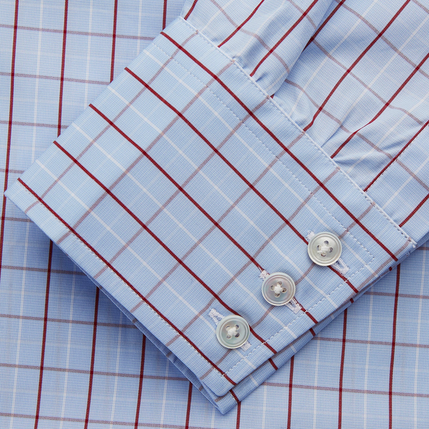 View 3 of product The Burgundy Graph Check Regular Fit Shirt by Turnbull & Asser features a T&A collar, 3-button cuffs, and a check pattern. Laid flat on a white background.