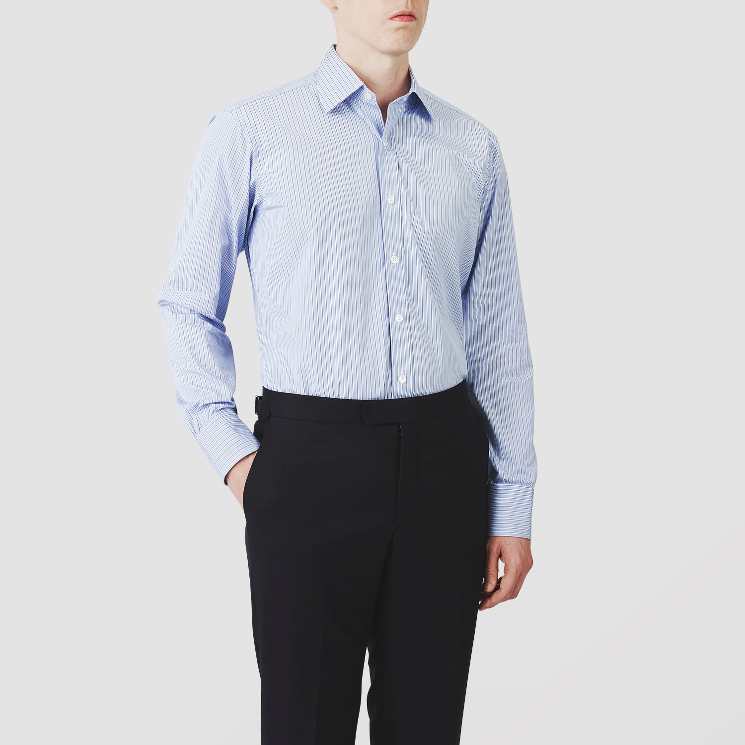 View 2 of product Turnbull & Asser’s Blue Stripe Shirt features thin vertical white stripes, a T&A collar, 3-button cuffs, white buttons, and a regular fit. Smart-casual style displayed flat on a white background.