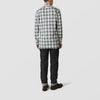 View 3 of product The Turnbull & Asser Green Check Shirt features a classic T&A collar, white buttons down the front and on 3-button cuffs, and a bold green, white, and black plaid pattern.