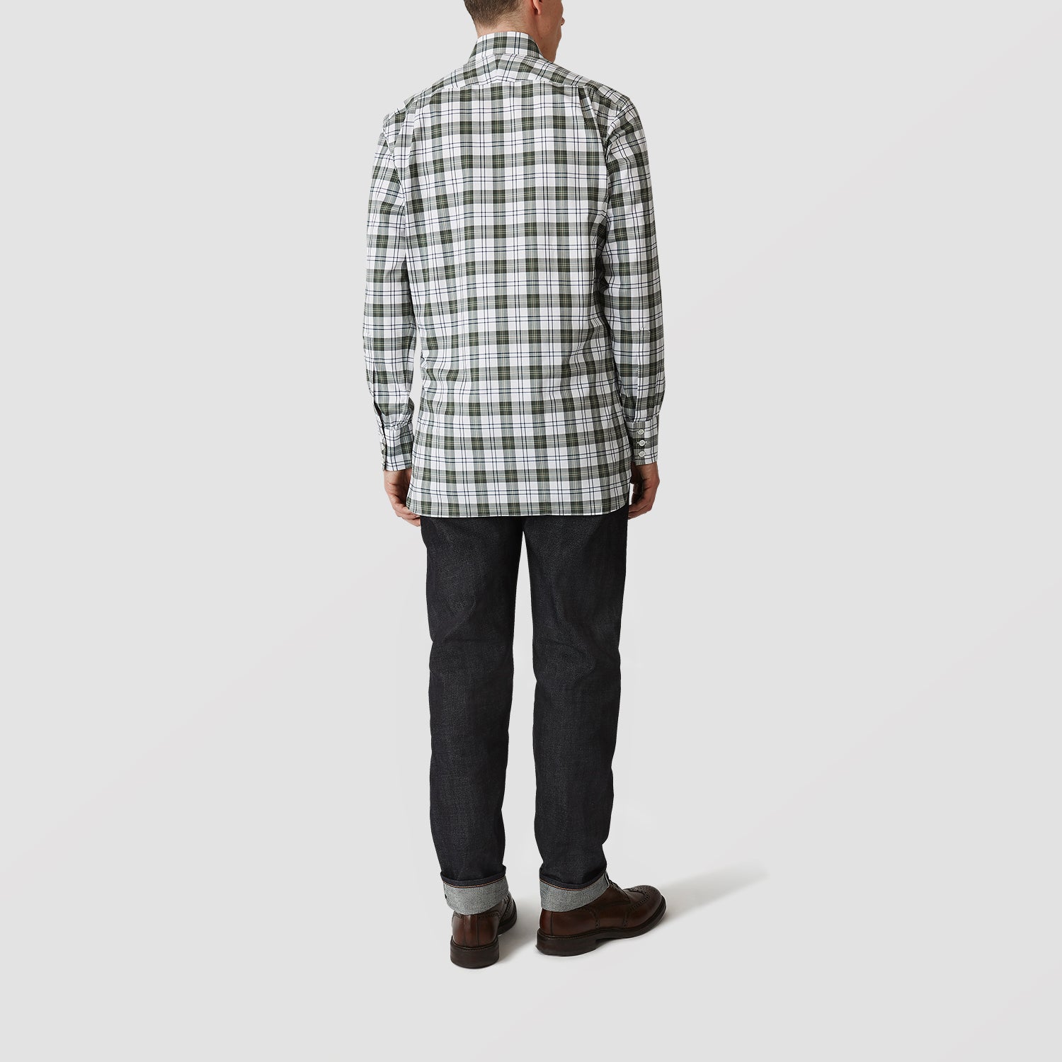 View 3 of product The Turnbull & Asser Green Check Shirt features a classic T&A collar, white buttons down the front and on 3-button cuffs, and a bold green, white, and black plaid pattern.